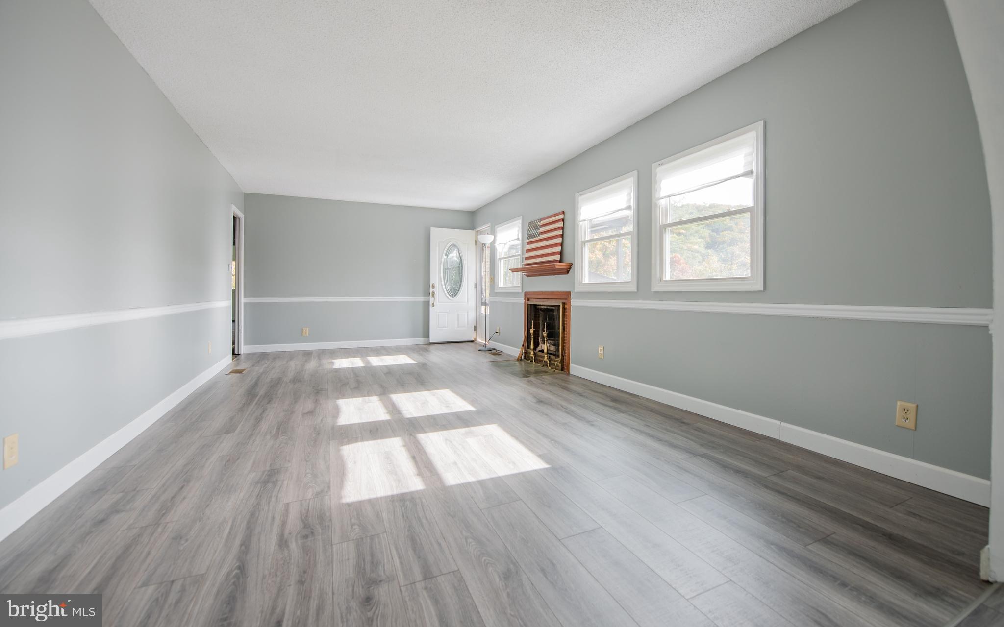 6 Oak Lane Lock Haven, PA 17745 - Photo 5 of 25 an empty room with wooden floor and windows
