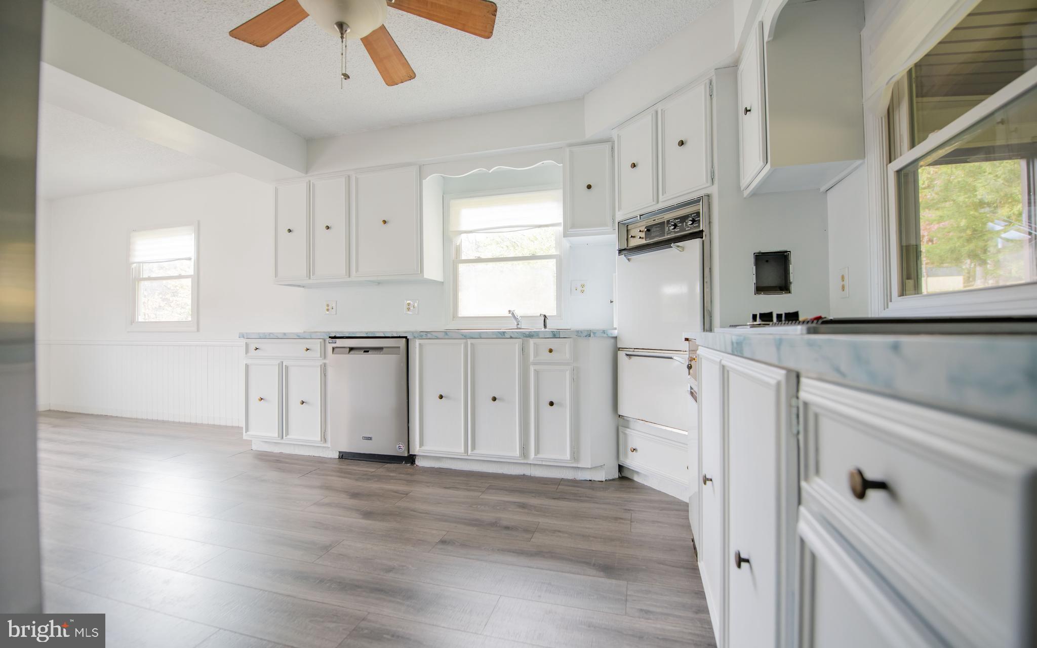 6 Oak Lane Lock Haven, PA 17745 - Photo 8 of 25 a kitchen with white cabinets and wooden floor