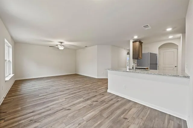 a kitchen with granite countertop a sink stove and cabinets