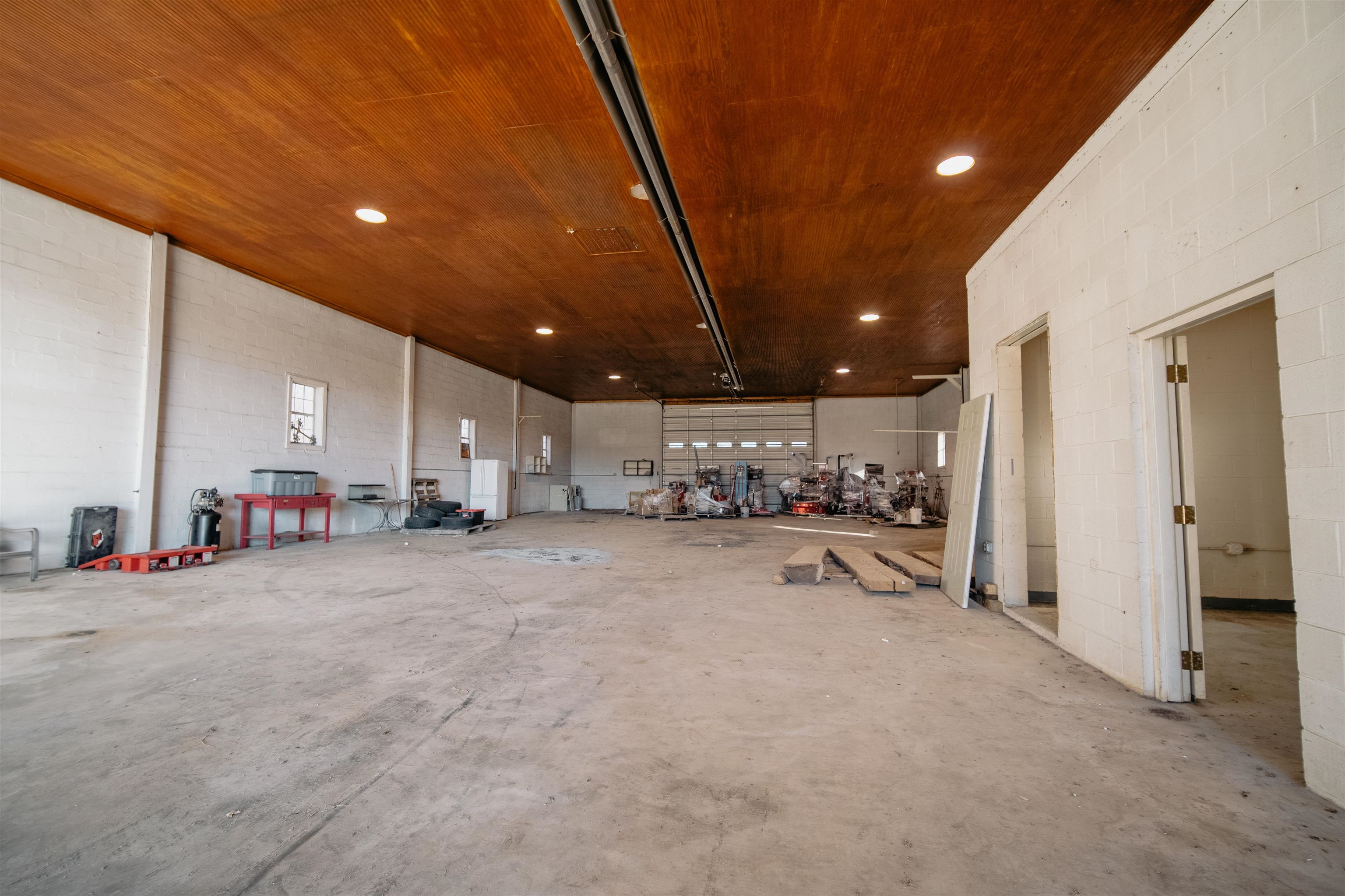 a view of a empty room with kitchen and a sink