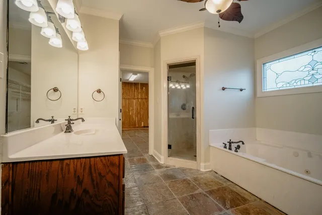 a spacious bathroom with a tub sink and shower