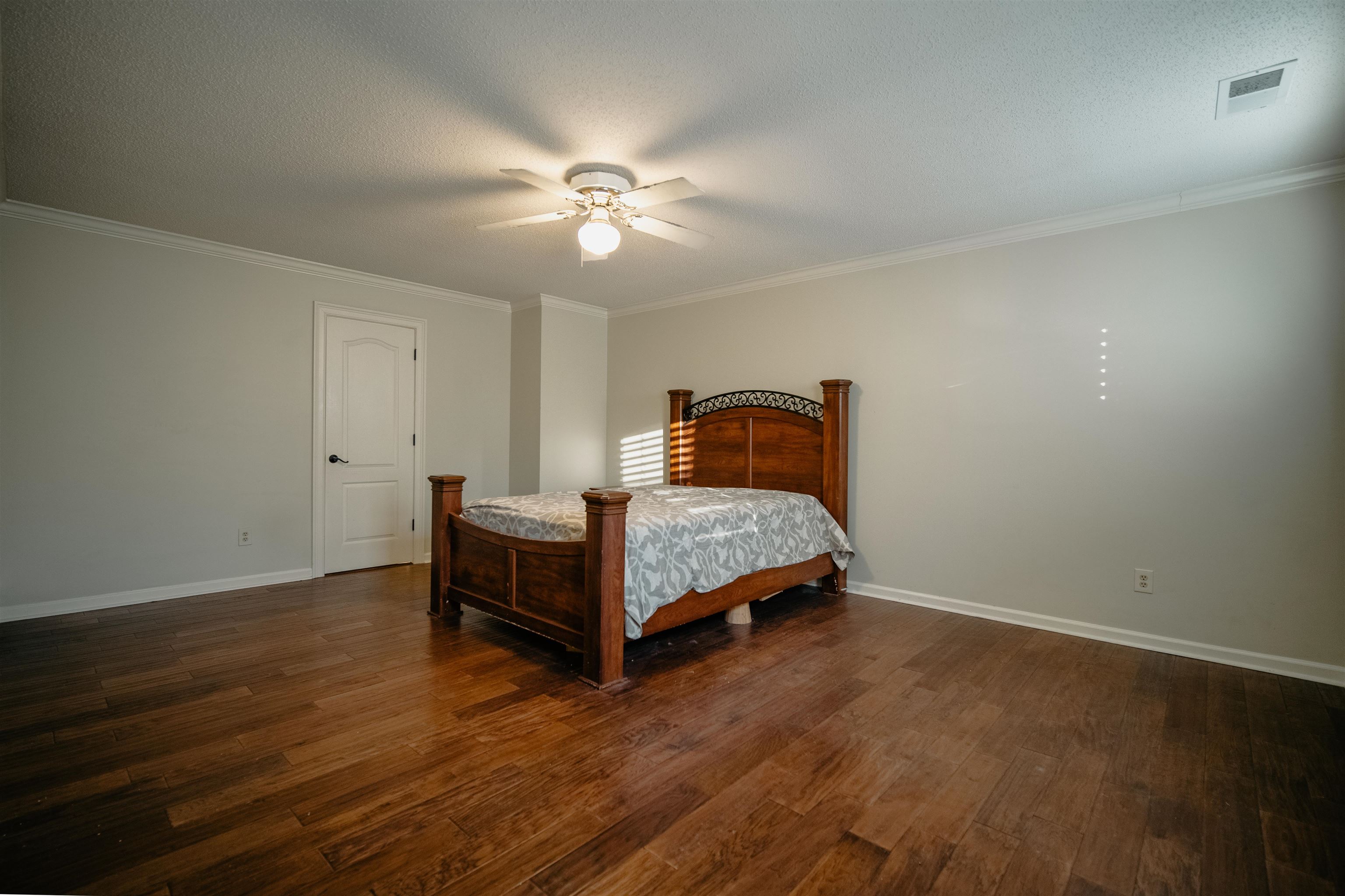 1275 Quinn Road Collierville, TN 38017 - Photo 15 of 34 a bedroom with a bed and a chandelier