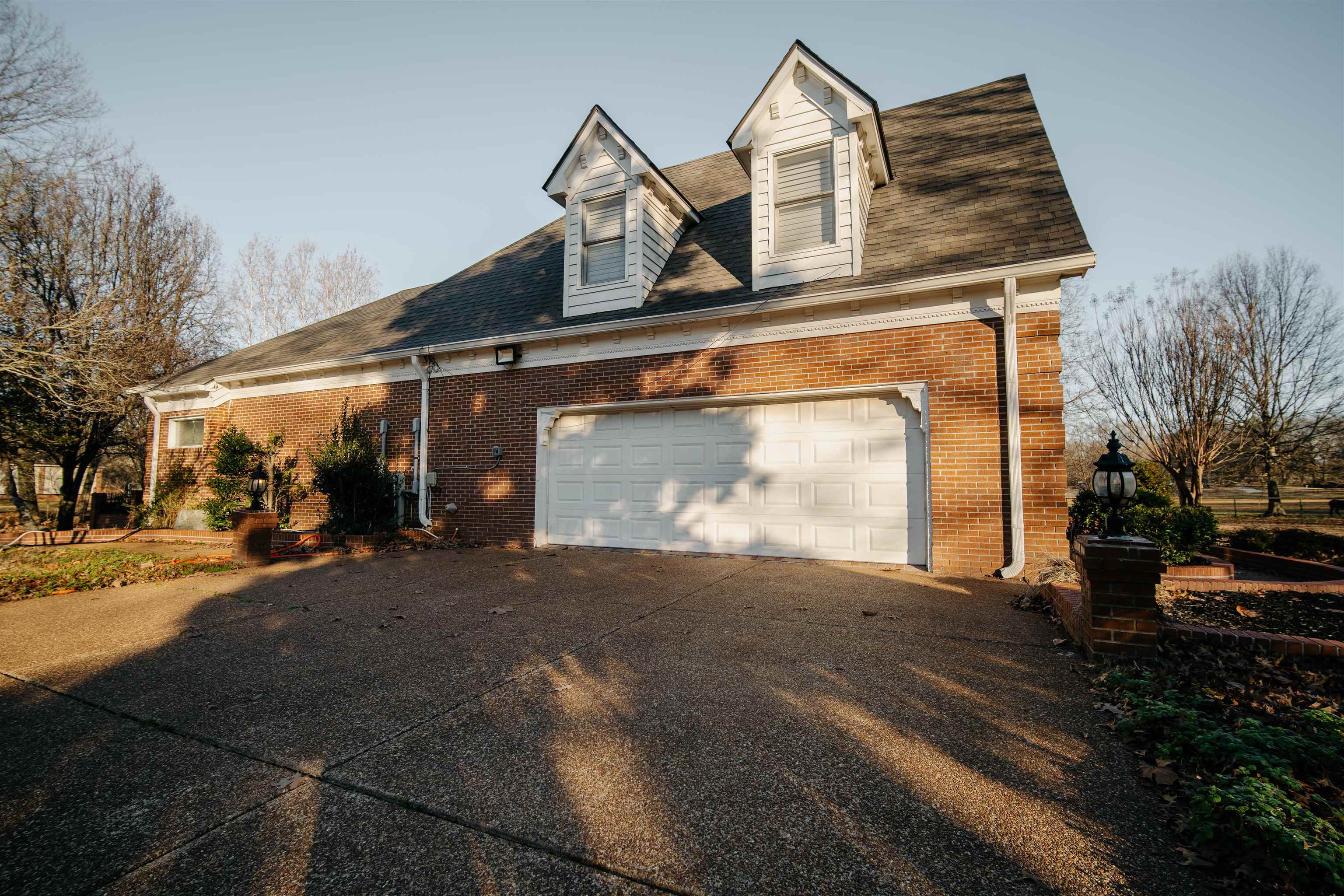 1275 Quinn Road Collierville, TN 38017 - Photo 2 of 34 a front view of a house with a yard and garage
