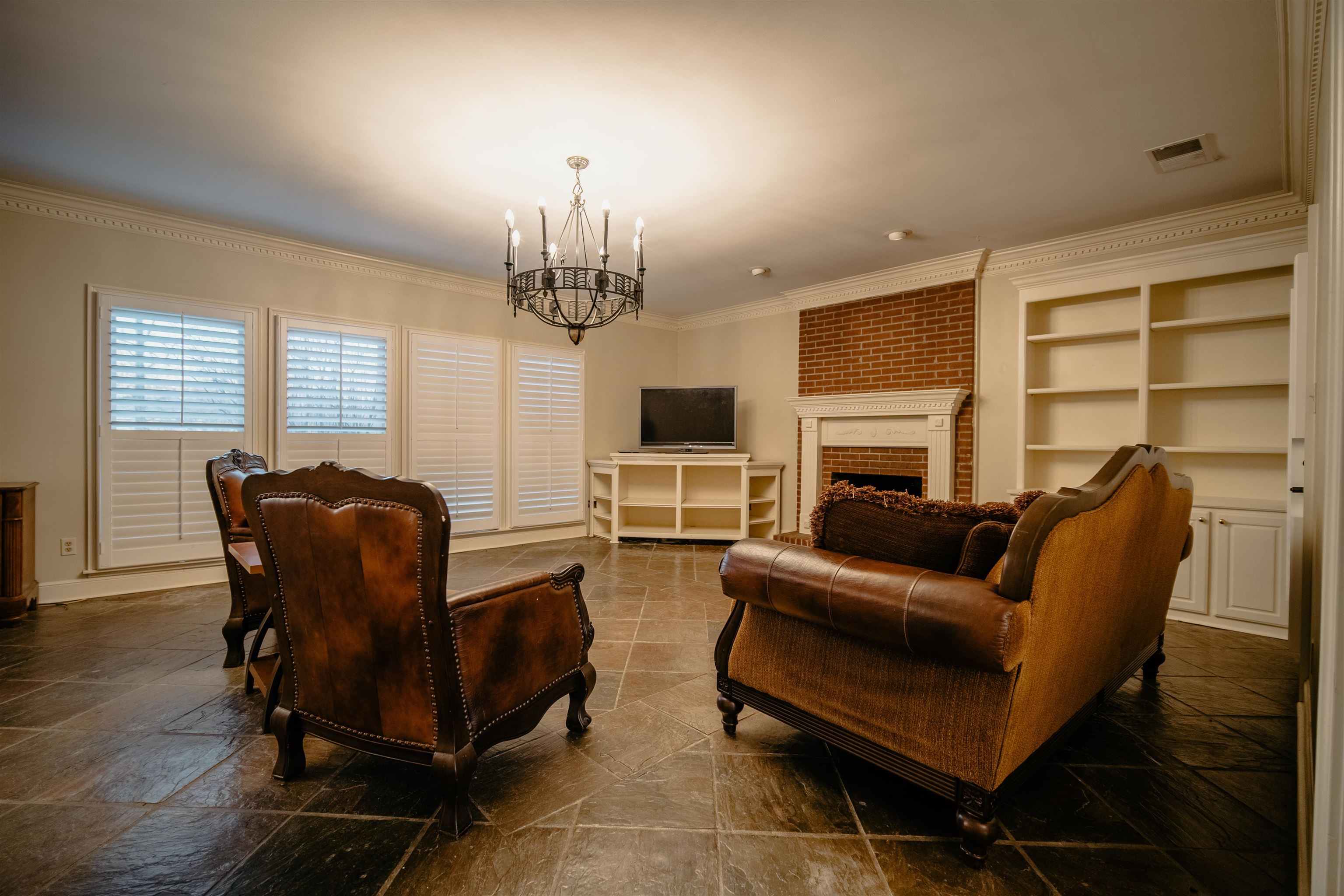 1275 Quinn Road Collierville, TN 38017 - Photo 6 of 34 a living room with furniture a fireplace and a flat screen tv