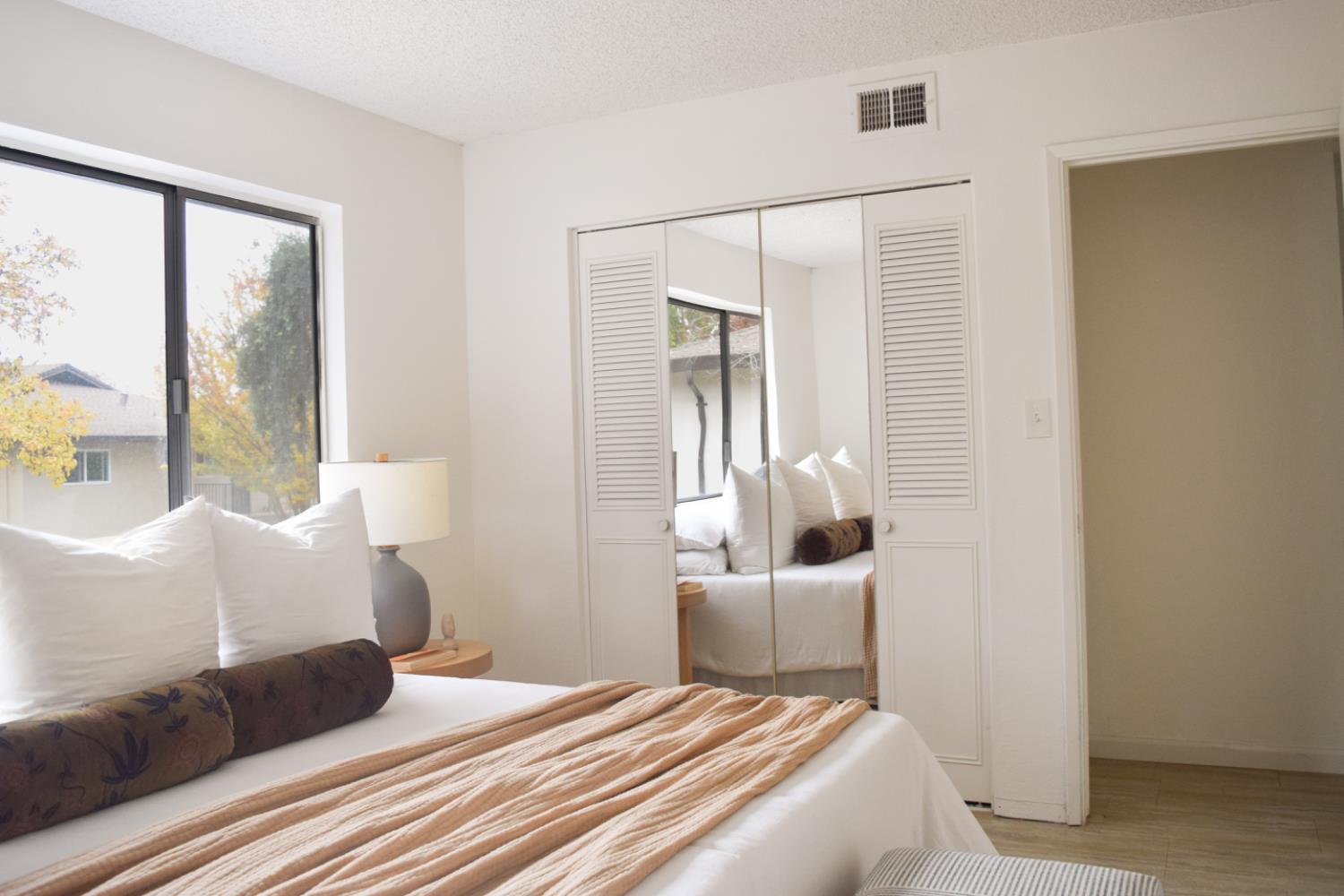 2708 Pole Line Road, Unit 4 Davis, CA 95618 - Photo 11 of 14 a bedroom with a large bed and a large window