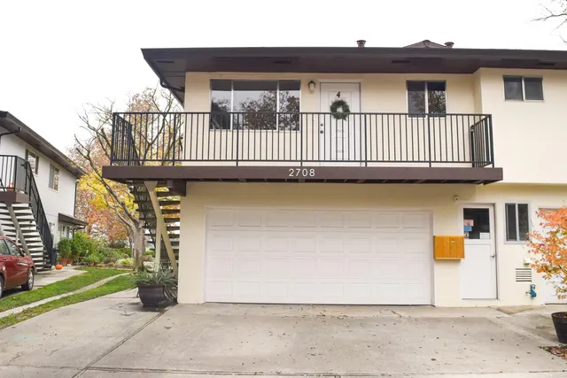 a view of a brick house with many windows
