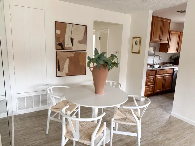 a dining room with stainless steel appliances granite countertop a dining table and chairs