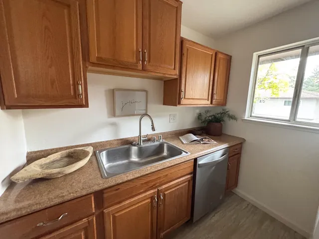 a bedroom with a large bed and a painting on the wall