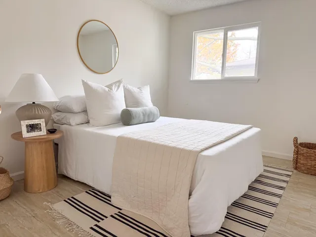 a bedroom with a bed and a window