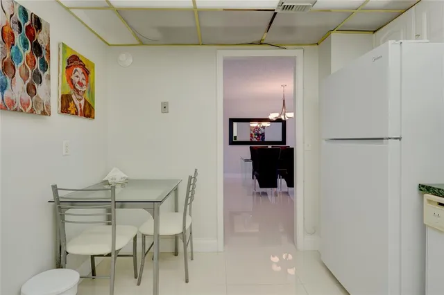 a dining room with wooden floor and hallway