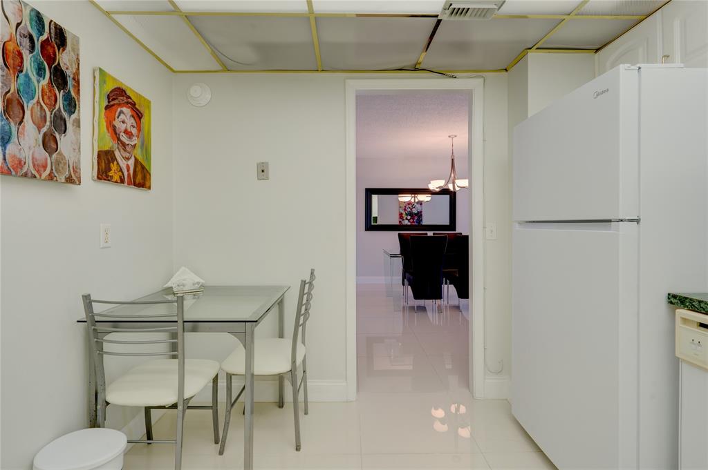 2000 South Ocean Boulevard, Unit 2L Lauderdale-by-the-Sea, FL 33062 - Photo 12 of 41 a dining room with wooden floor and hallway