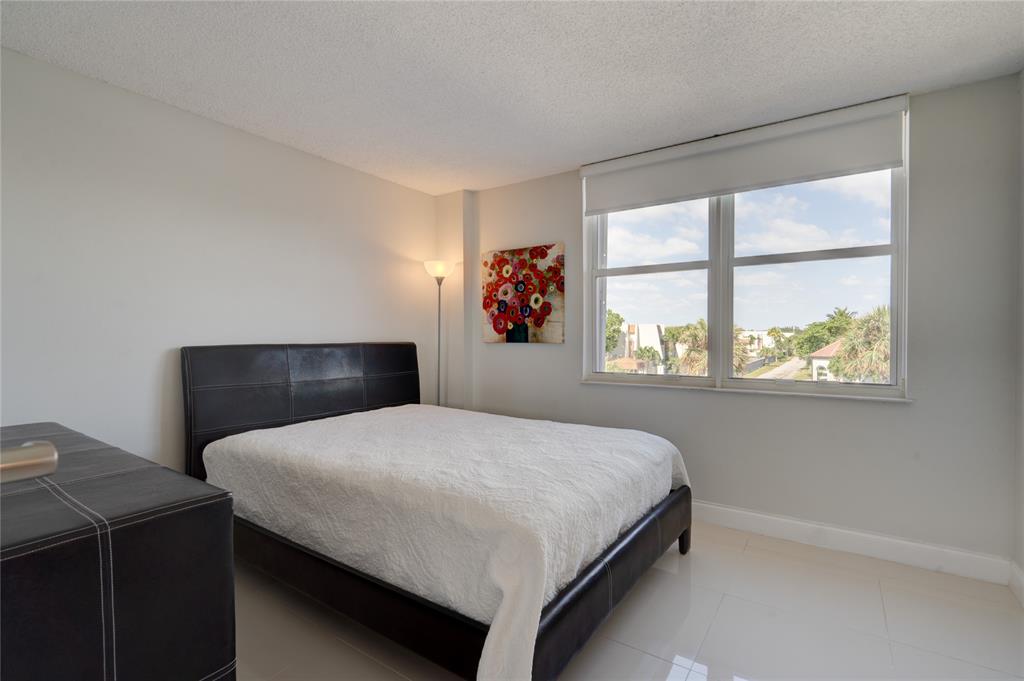 2000 South Ocean Boulevard, Unit 2L Lauderdale-by-the-Sea, FL 33062 - Photo 13 of 41 a bedroom with a bed and a window