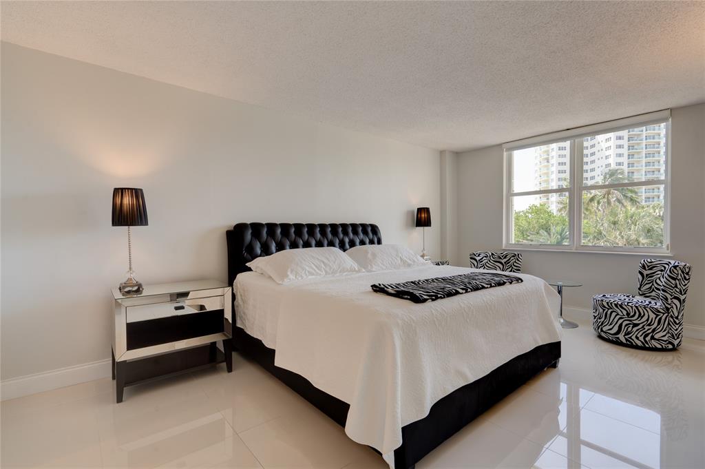 2000 South Ocean Boulevard, Unit 2L Lauderdale-by-the-Sea, FL 33062 - Photo 16 of 41 a bedroom with a bed and window