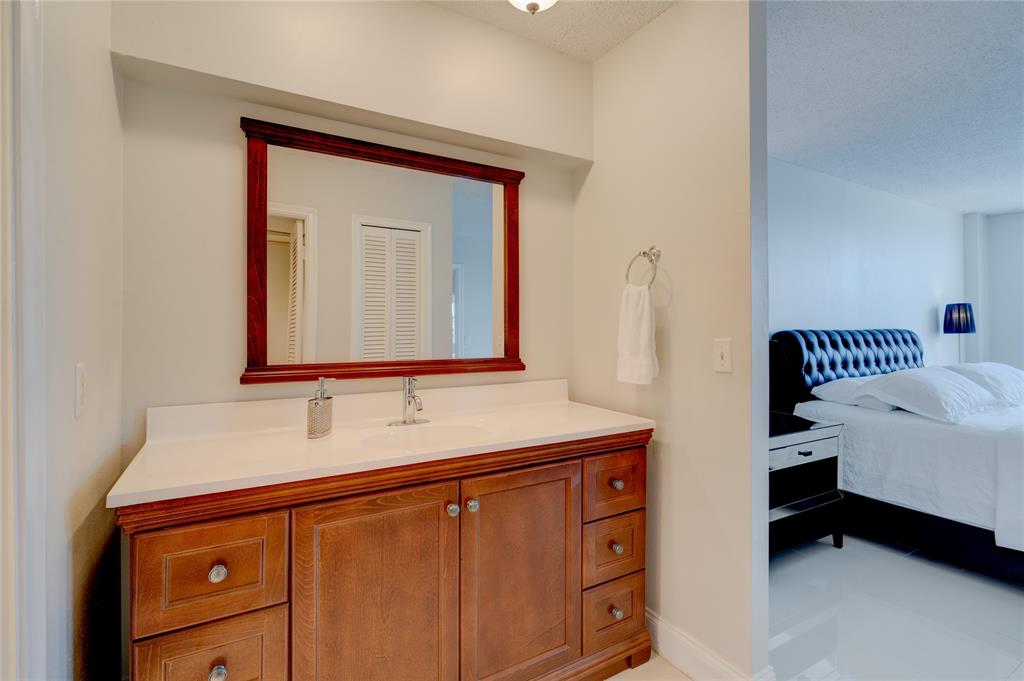 2000 South Ocean Boulevard, Unit 2L Lauderdale-by-the-Sea, FL 33062 - Photo 21 of 41 a bathroom with a sink and a mirror