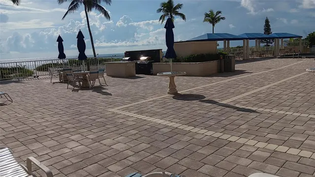 a front view of a house with a yard and outdoor seating