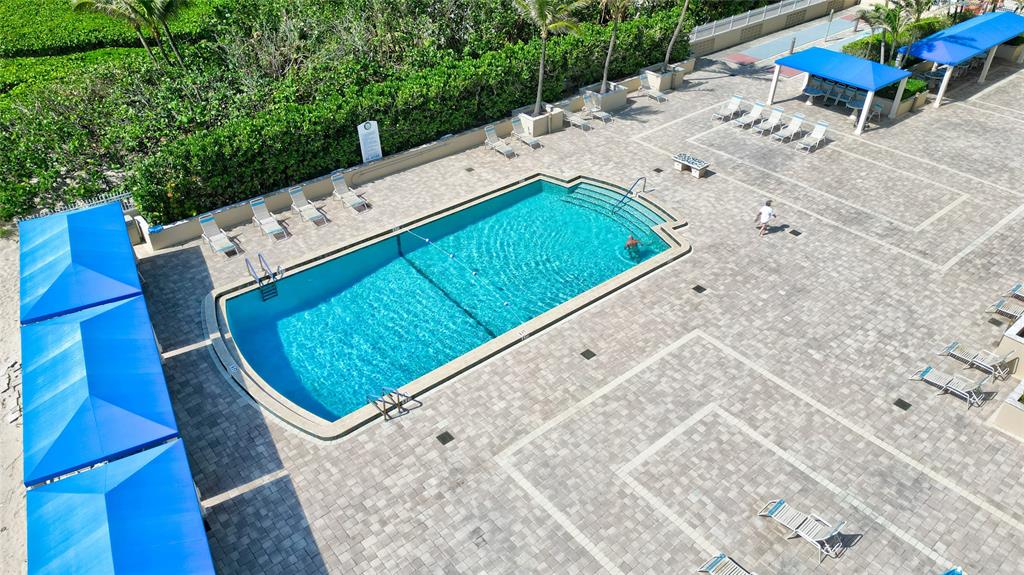 2000 South Ocean Boulevard, Unit 2L Lauderdale-by-the-Sea, FL 33062 - Photo 39 of 41 a view of a pool with chairs