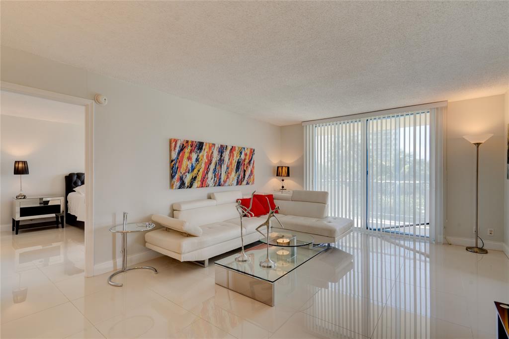 2000 South Ocean Boulevard, Unit 2L Lauderdale-by-the-Sea, FL 33062 - Photo 4 of 41 a living room with furniture and a window