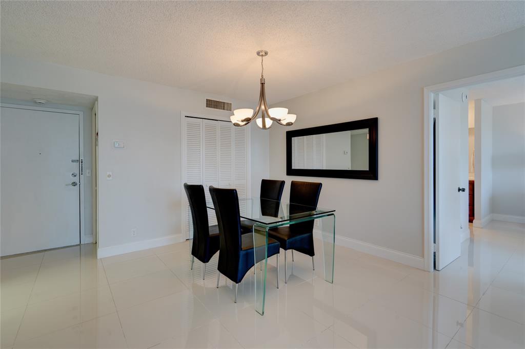 2000 South Ocean Boulevard, Unit 2L Lauderdale-by-the-Sea, FL 33062 - Photo 5 of 41 a dining room with furniture and window