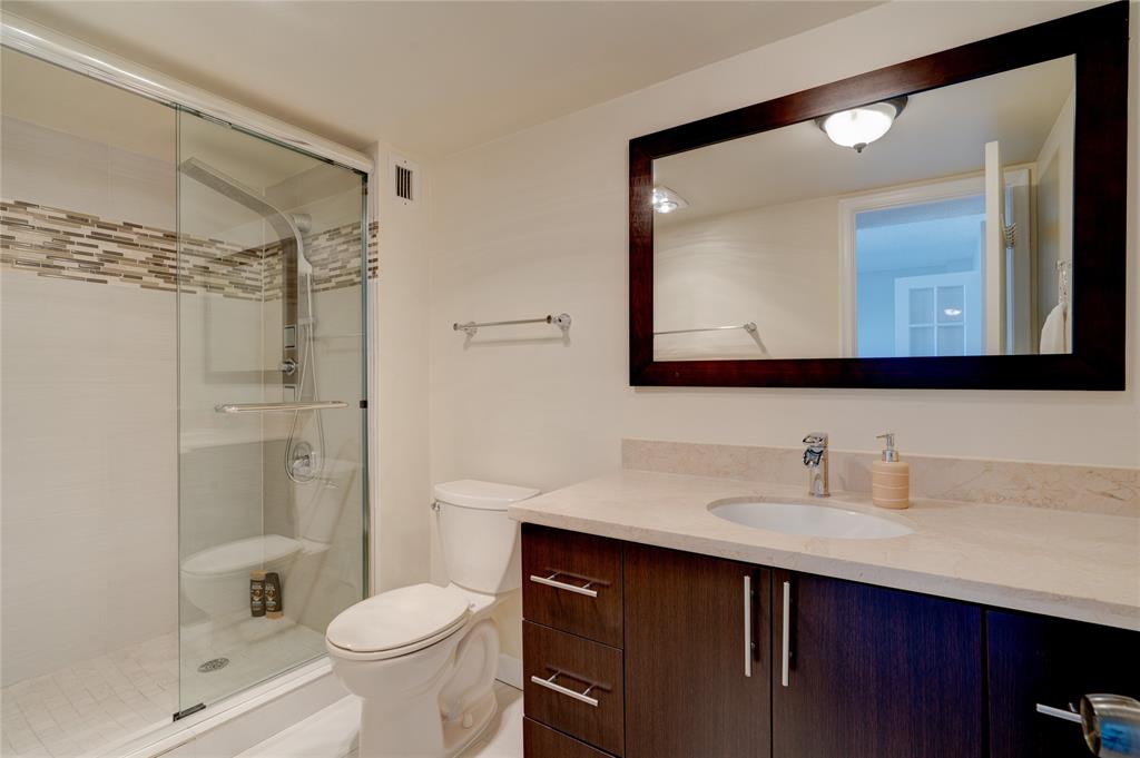 2000 South Ocean Boulevard, Unit 2L Lauderdale-by-the-Sea, FL 33062 - Photo 8 of 41 a bathroom with a sink vanity mirror and toilet