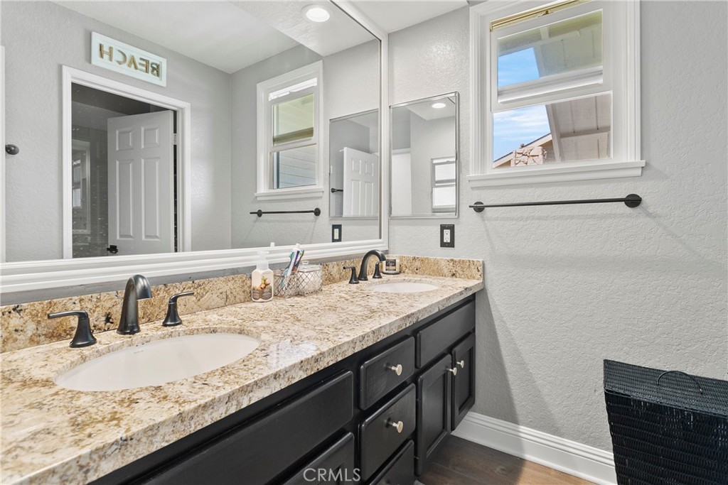 404 Calle Macho San Clemente, CA 92673 - Photo 13 of 19 a bathroom with a granite countertop sink and a mirror