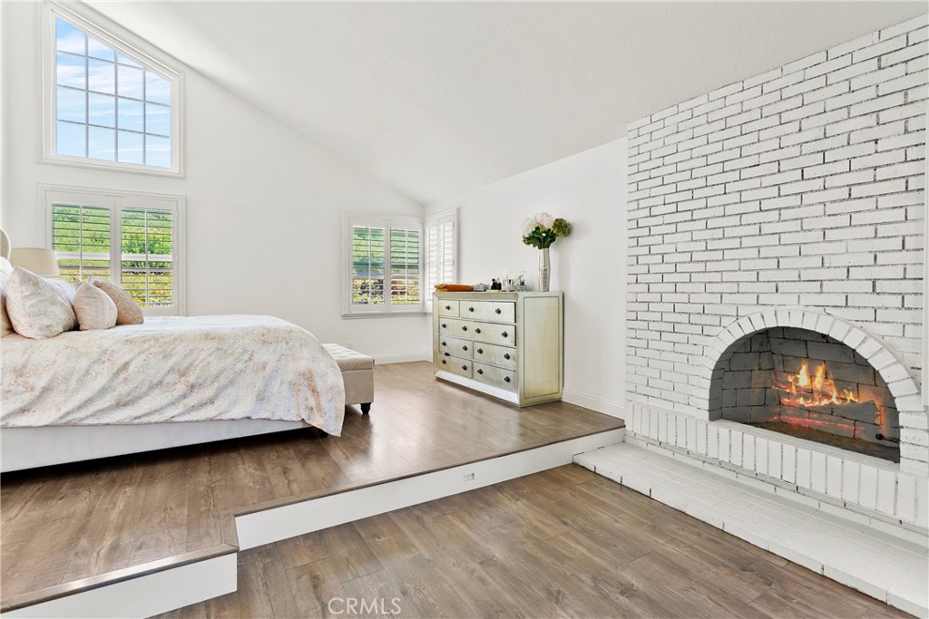404 Calle Macho San Clemente, CA 92673 - Photo 16 of 19 a bedroom with a bed and a fireplace
