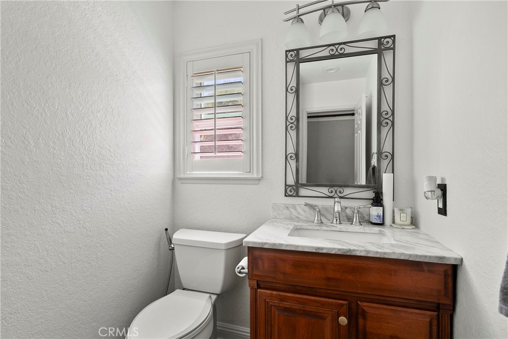 404 Calle Macho San Clemente, CA 92673 - Photo 9 of 19 a bathroom with a granite countertop toilet sink and mirror
