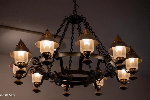 a large room with a bed and a view of kitchen