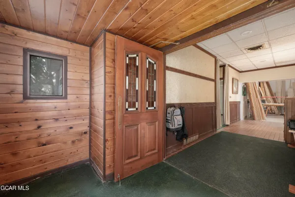 a view of hallway with furniture and a window