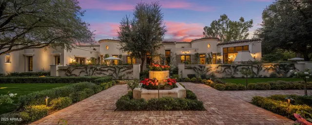 a front view of a house with a garden