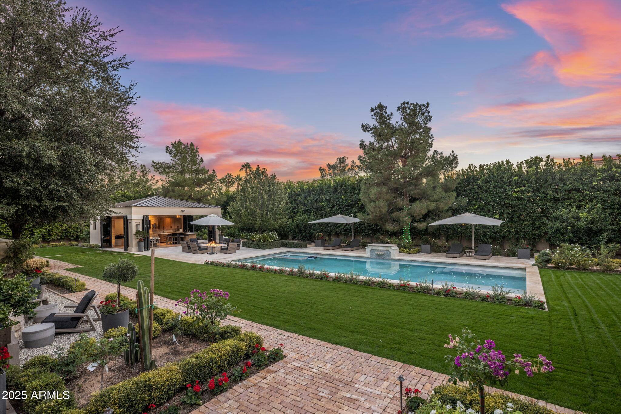 8345 Morning Glory Road Paradise Valley, AZ 85253 - Photo 11 of 37 a view of a house with swimming pool and a yard