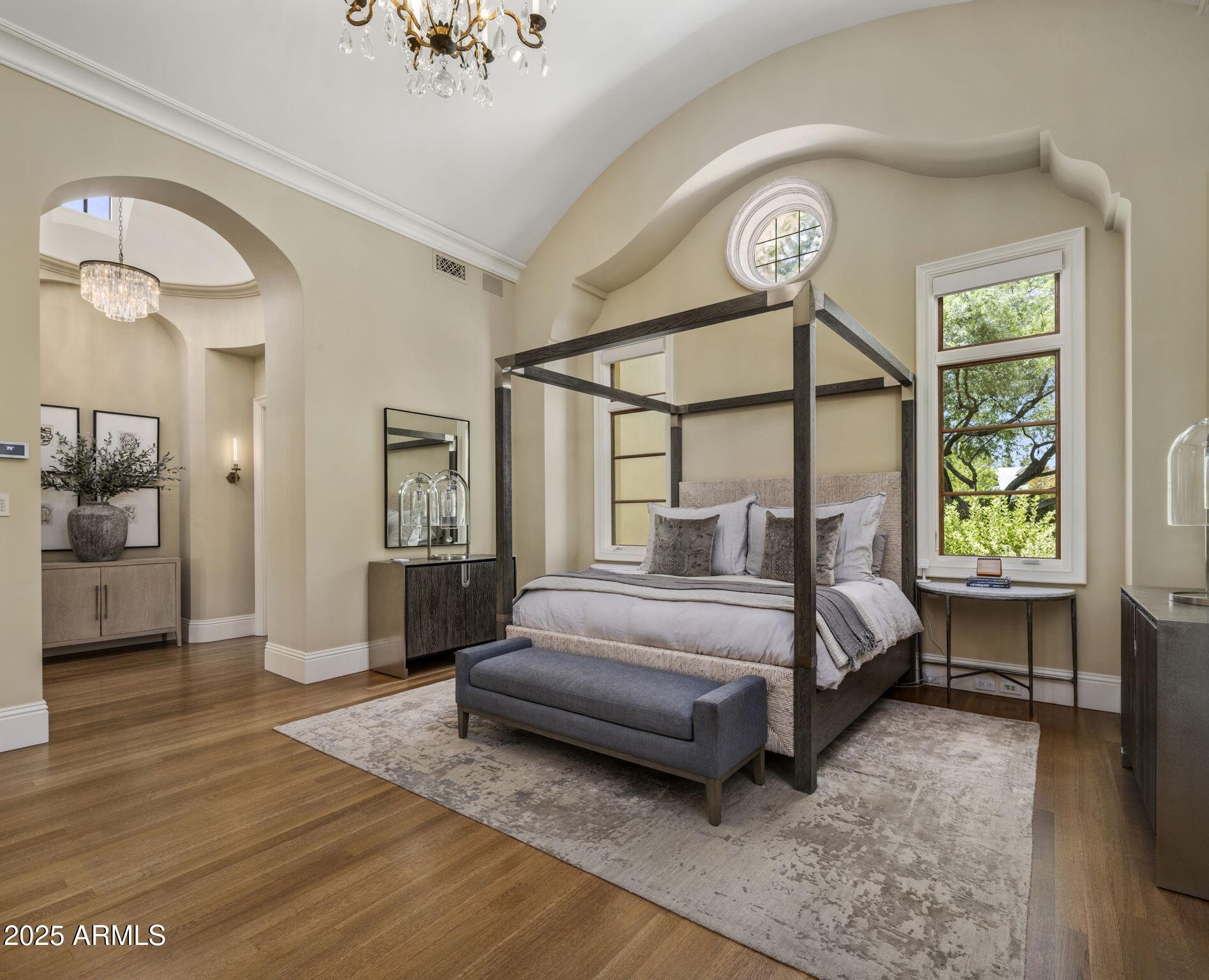 8345 Morning Glory Road Paradise Valley, AZ 85253 - Photo 17 of 37 a bedroom with a bed a chandelier and a window