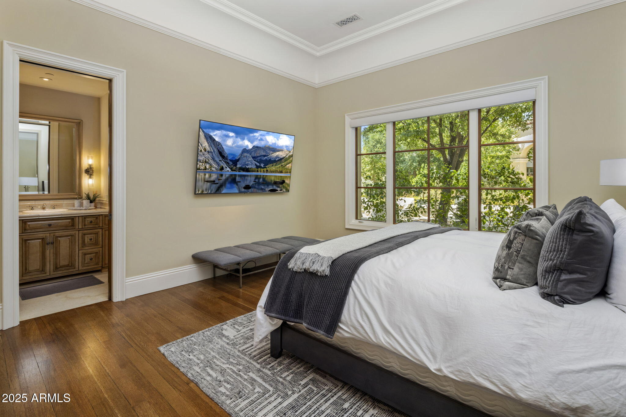 8345 Morning Glory Road Paradise Valley, AZ 85253 - Photo 21 of 37 a bedroom with a bed and wooden floor