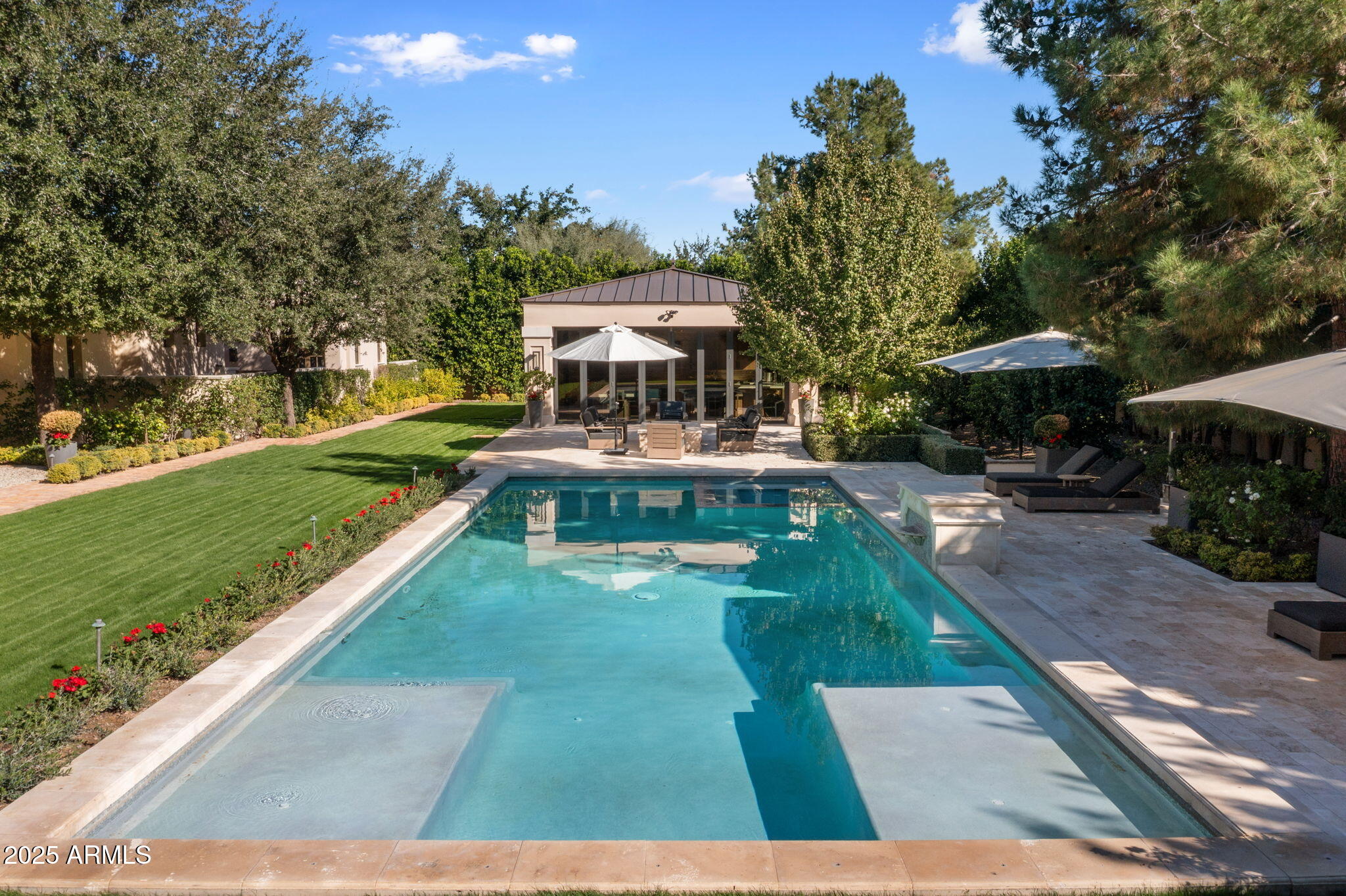 8345 Morning Glory Road Paradise Valley, AZ 85253 - Photo 32 of 37 a view of a patio with a table and chairs under an umbrella