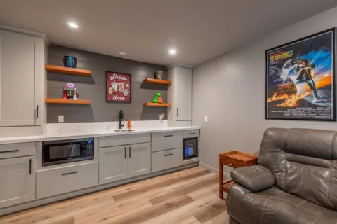 a living room with furniture and kitchen view
