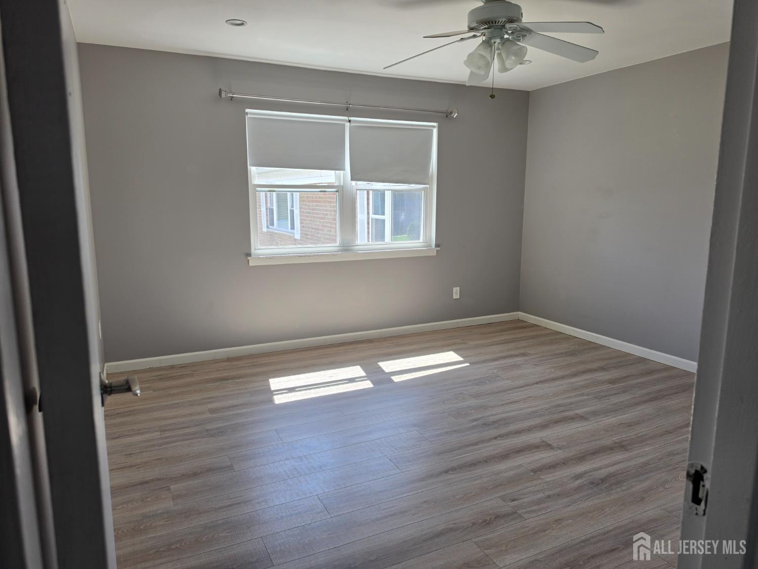 192 Evergreen Road, Unit 7B Edison, NJ 08837 - Photo 17 of 21 a view of empty room with wooden floor and fan