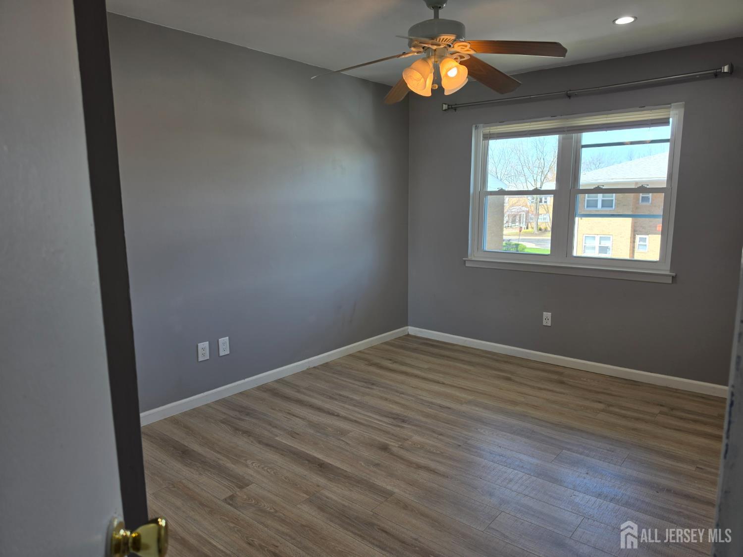 192 Evergreen Road, Unit 7B Edison, NJ 08837 - Photo 18 of 21 an empty room with a window and wooden floor