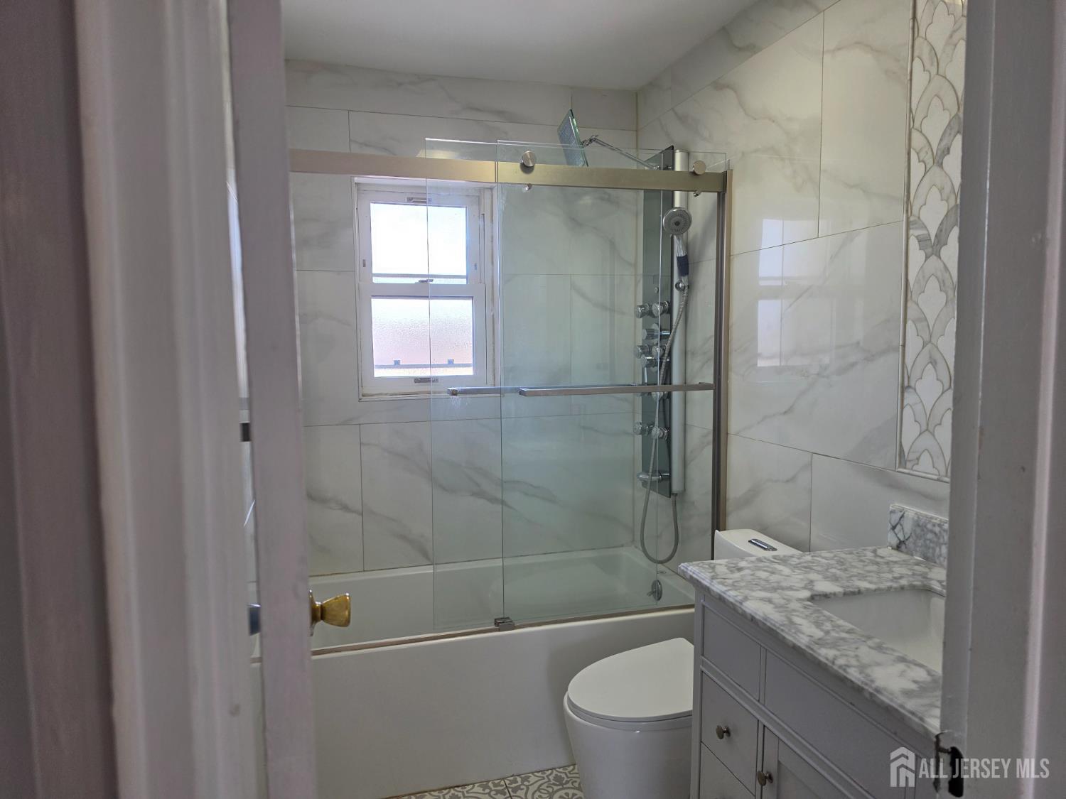 192 Evergreen Road, Unit 7B Edison, NJ 08837 - Photo 20 of 21 a bathroom with a granite countertop toilet a sink and shower