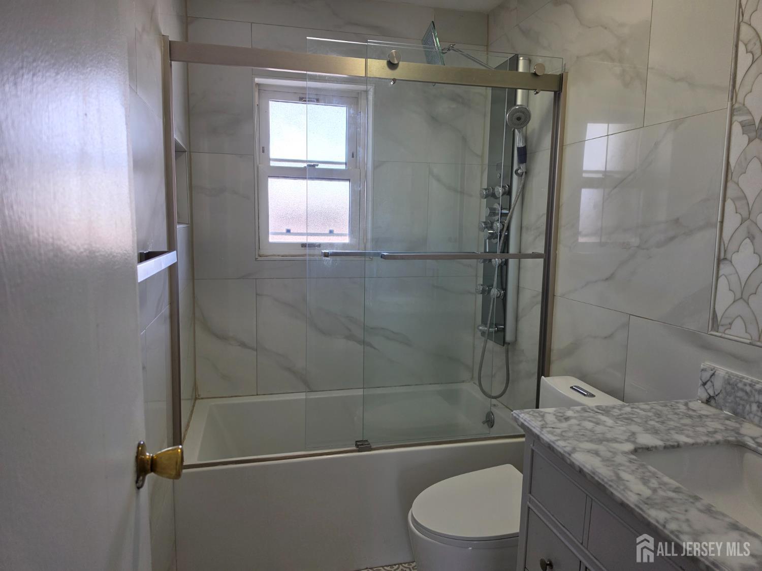 192 Evergreen Road, Unit 7B Edison, NJ 08837 - Photo 21 of 21 a bathroom with a granite countertop bathtub shower sink vanity and toilet