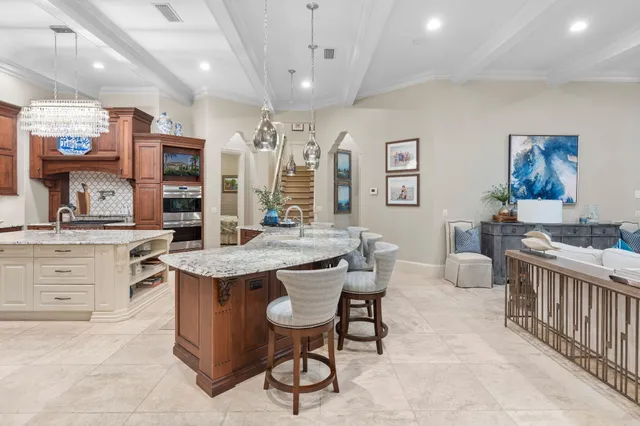 a bathroom with a granite countertop sink a toilet a mirror and shower