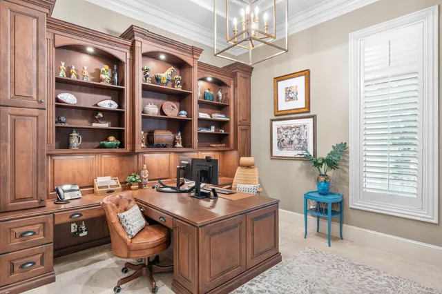 a view of a workspace with furniture and a window