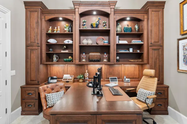 a kitchen with stainless steel appliances kitchen island granite countertop a table chairs and a refrigerator