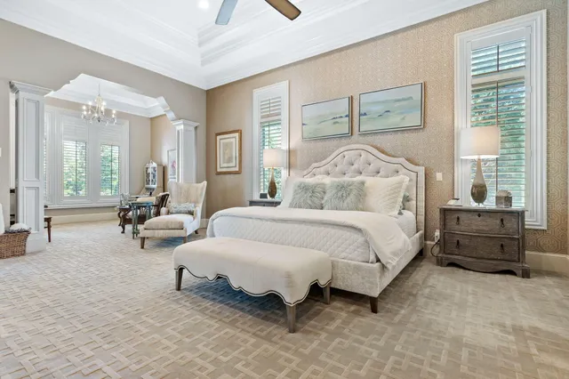 a living room with furniture a ceiling fan and a flat screen tv
