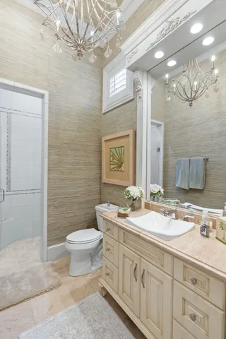 a kitchen with stainless steel appliances kitchen island granite countertop a table chairs and a refrigerator