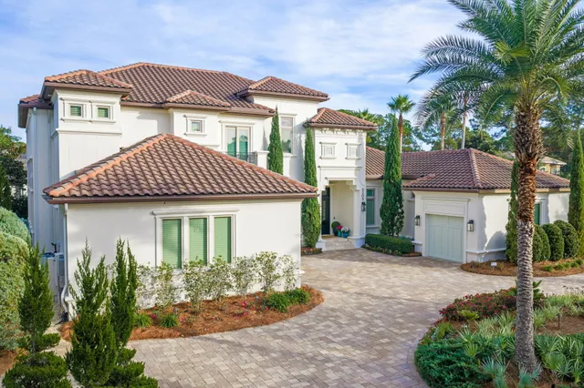 a living room with furniture kitchen view and a wooden floor