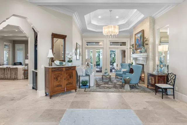 a living room with furniture and a painting on the wall