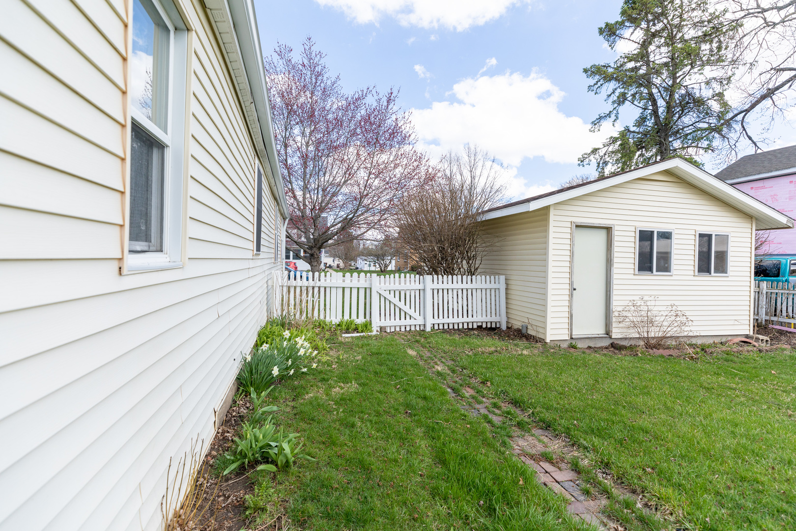 916 North 8th Street Rochelle, IL 61068 - Photo 13 of 16 a view of a house with a yard and wooden fence