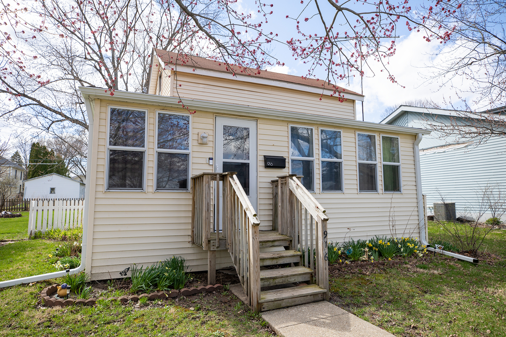 916 North 8th Street Rochelle, IL 61068 - Photo 3 of 16 a view of a house with a large windows and flower plants