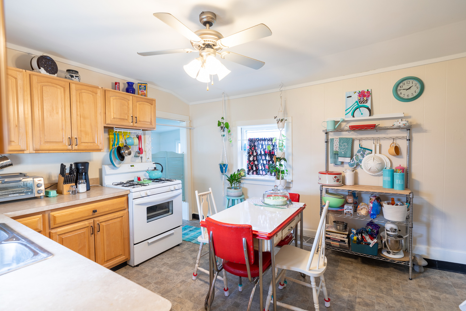 916 North 8th Street Rochelle, IL 61068 - Photo 9 of 16 a open kitchen with stainless steel appliances granite countertop a stove a sink a dining table and chairs with wooden floor
