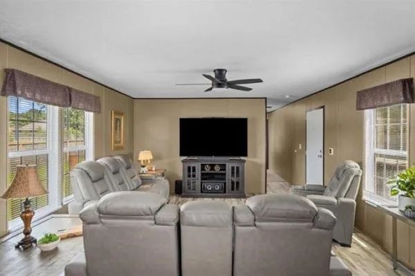 a living room with furniture and a flat screen tv
