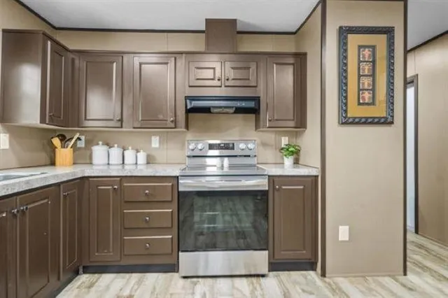 a kitchen with stainless steel appliances granite countertop a stove and cabinets